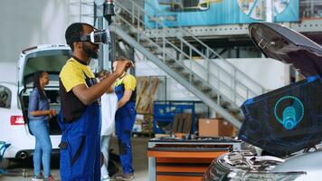 Qualified technician in repair shop using advanced virtual reality technology to visualize car mechanical component in order to fix it. Garage expert wearing vr glasses while repairing damaged vehicle photo