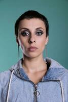 Portrait of happy woman with gorgeous makeup posing with confidence, standing over isolated background. Caucasian female feeling positive and confident looking at camera, indoors shot photo