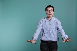 Afraid terrified woman having scared expression after hearing the bad news, nervous person standing in studio posing over isolated background. Frightened female looking at camera with shock reaction photo