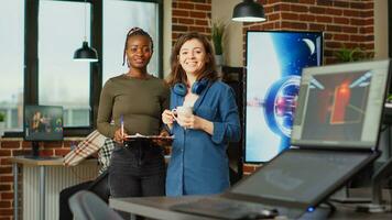 Professional friendly people doing teamwork to brainstorm ideas in creative agency studio, looking at engineering notes on papers. Women developing manufacturing project with artistic skills. photo