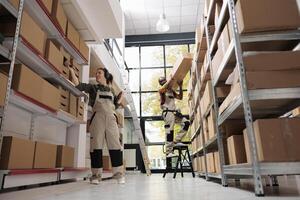 Storage room worker scanning products barcode using store scanner, checking cardboard box details during warehouse inventory. Supervisor listening music while preparing customers orders photo