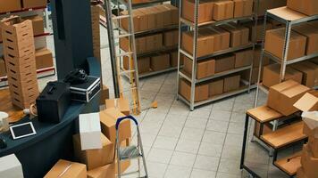 Empty warehouse with stacks of cardboard packages, small business concept with shelves and racks of merchandise. Product packed in boxes used for shipment and delivery, storage room. photo