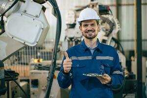 Engineer worker Hispanic Latin in Machine Robotic modern Automation Industry. Happy Mechanic staff employee in metal factory. photo