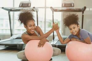 happy sport fitness healthy woman with child smiling in sport club treadmill background photo