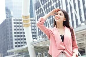 Happy smiling business woman standing outdoor looking high not fear hot UV sunlight from high protection sunscreen skin care photo