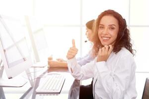 call center female team tele sale agent happy smiling thumbs up. Good service CRM or help desk. photo