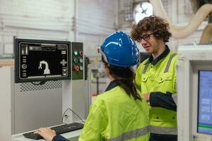 technician engineer training tralking together. worker technician team control operate industry robot arm computer machine photo