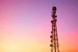 4G or 5G digital data telecommunication tower network telephone cell site with blank dusk sky copy space for text, communication internet infrastructure technology. photo