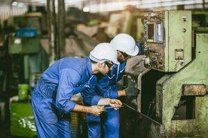lathe technician engineer worker service team check maintenance milling head lathe CNC machine in heavy metal industry factory photo