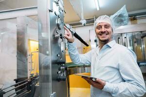 happy fatory engineer technician machine operate config setting working in food and drink factory photo