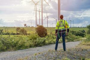 Wind turbine technician checking service. Engineer team professional working maintenance clean power generator system photo