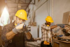 carpenter joiner worker men work in furniture factory, professional wood worker staff employee handcraft in wood workshop. photo