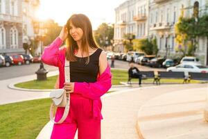 Pretty woman in stylish casual outfit  posing  in old european city. Warm sunset color. Summer mood. photo