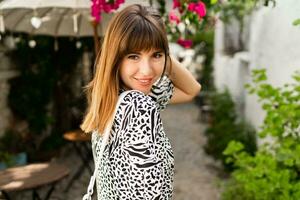 Outdoor portrait of pretty woman posing in  old  Turkey city Alacati. photo