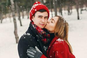 Young  happy loving couple on natural winter park  background. photo