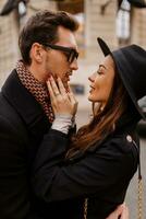 Happy romantic couple face to face, flirting and hugging each other on the street. photo