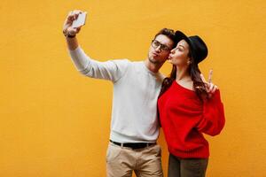 Handsome  white man with beard and cute playful brunette woman making sel portrait. photo