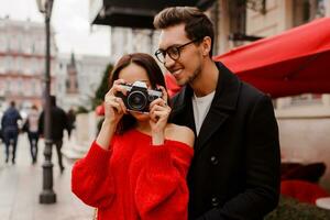 Happy traveling couple embarrassing and  posing on the street on holiday. photo