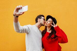 Happy girl with her boyfriend making self portrait by mobile phone. photo