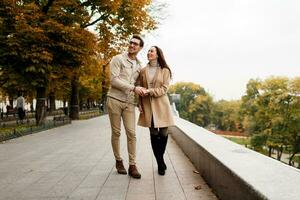 Outdoor  photo of happy young woman with her boyfriend enjoying date. Cold season.