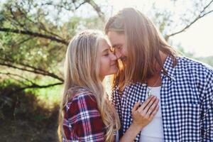Close up summer warm  romantic  portrait of two people, couple in love kissing and hugging. Warm cozy colors. photo