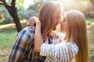 Close up summer warm  romantic  portrait of two people, couple in love kissing and hugging. Warm cozy colors. photo