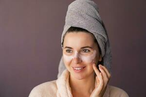 Skin care. Woman  using mask to her face. The girl takes care of oily skin. Cosmetic procedures. photo
