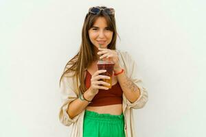 Summer portrait of stylish brunette woman  enjoing sweety lemonade and posing on white background. photo