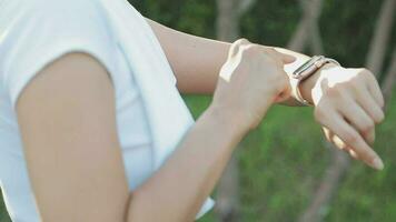 Young woman stretching before running while looking for beautiful landscape on roadside. Sports and Recreation video