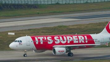 PHUKET, THAILAND FEBRUARY 03, 2023 - Airbus A320, 9MAHL AirAsia with AirAsia Super App Livery taxiing at Phuket airport. Asian low cost airline. Airfield. Tourism and travel concept video