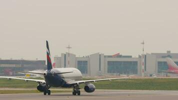 MOSCOW, RUSSIAN FEDERATION JULY 28, 2021 - Airbus A320 of Aeroflot on taxiway at Sheremetyevo airport, side view. Airplane taxiing. Concept transport aviation video