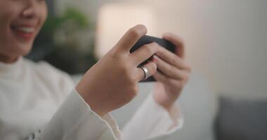 Asian woman playing a game on smartphone photo