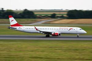 Austrian Airlines passenger plane at airport. Schedule flight travel. Aviation and aircraft. Air transport. Global international transportation. Fly and flying. photo