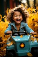 little girl in a yellow car rides down a track full of leaves photo