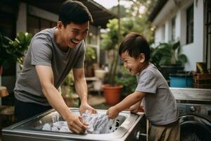 Father and Son Doing Laundry Together to load the washing machine with dirty clothes photo