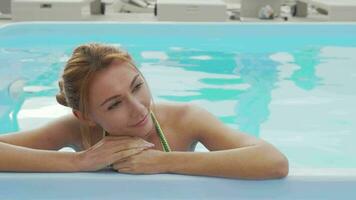 Gorgeous woman relaxing in outdoors swimming pool video