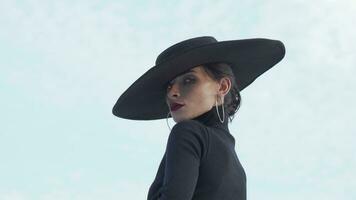 Beautiful mysterious woman wearing red lips and black hat looking to the camera video