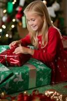 Cute girl unwrapping Christmas - AI generated photo