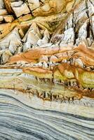 a close up of a rock formation with different colors photo