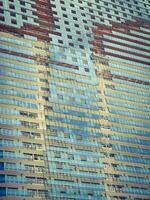 Unfinished modern building with blue mirrored exterior. photo