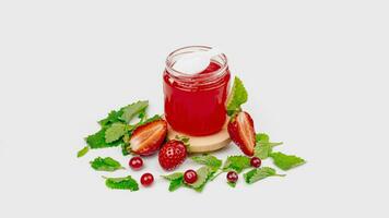 Fruit jelly in a jar with fresh strawberry and mint. Mockup dessert. Healthy food. Close-up Strawberry jelly on white background. Free space for text photo