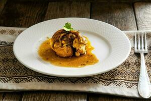 Buckwheat porridge with butter in a blue bowl on wooden table photo