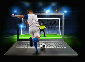 Live streaming of a soccer player match on a laptop photo