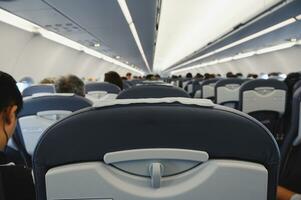 Interior of an airliner with traveler people photo