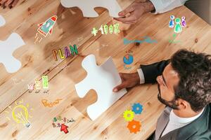 Businessmen working together to build a puzzle as teamwork, partnership and integration concept photo