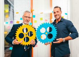 Business team work together and combine pieces of gears as partnership and integration concept photo