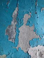 Blue paint on old concrete wall with cracks as background texture photo