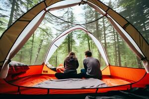 A man and a woman sit in a tourist tent with a transparent top and enjoy the view of nature. View from the back, inside the tent.  AI Generative photo