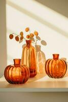 AI Generative. Several transparent glass vases in the form of an orange pumpkin stand on the table illuminated by the sun's rays. Vertical photo