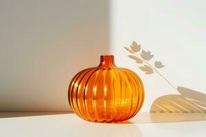AI Generative. Large orange glass pumpkin against a white wall. The wall is illuminated by bright sunlight. Pumpkins silhouetted on a white wall. Horizontal photo